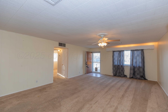 empty room with light colored carpet and ceiling fan