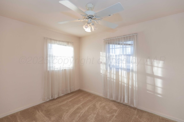 carpeted spare room with ceiling fan and a healthy amount of sunlight