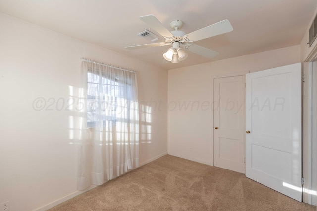 carpeted empty room featuring ceiling fan