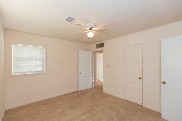 unfurnished bedroom with ceiling fan and light carpet