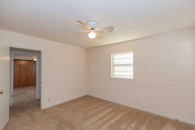 carpeted spare room featuring ceiling fan