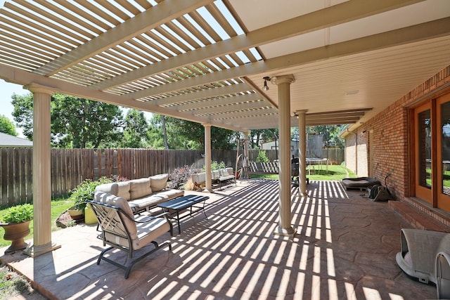 1206 Olive St, Stratford, TX 79084 - fenced backyard with a trampoline, a pergola, a patio, and an outdoor living space