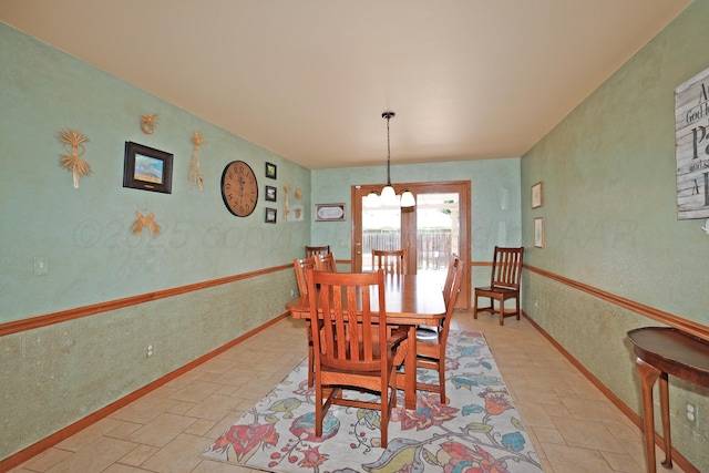 1206 Olive St, Stratford, TX 79084 - dining room with stone tile floors and a chandelier
