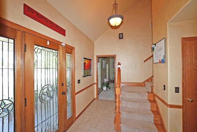 1206 Olive St, Stratford, TX 79084 - entrance foyer with light stone finish floors, stairway, and high vaulted ceiling