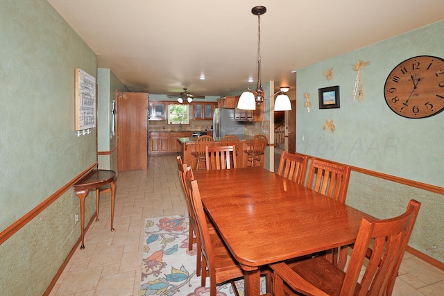 1206 Olive St, Stratford, TX 79084 - dining space featuring a ceiling fan, a textured wall, and stone tile flooring