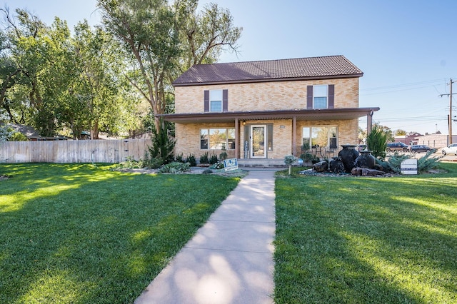 view of front facade featuring covered porch and a front lawn