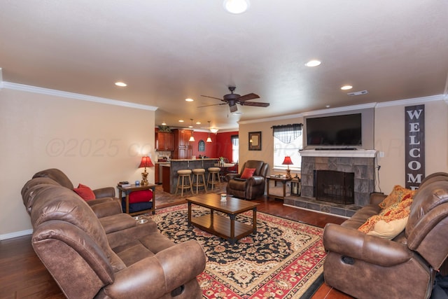2101 Bowie St, Amarillo, TX 79109 - living room with crown molding, ceiling fan, a tiled fireplace, dark wood-style flooring, and recessed lighting