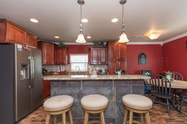 2101 Bowie St, Amarillo, TX 79109 - kitchen with stainless steel refrigerator with ice dispenser, brick flooring, crown molding, a kitchen bar, and backsplash