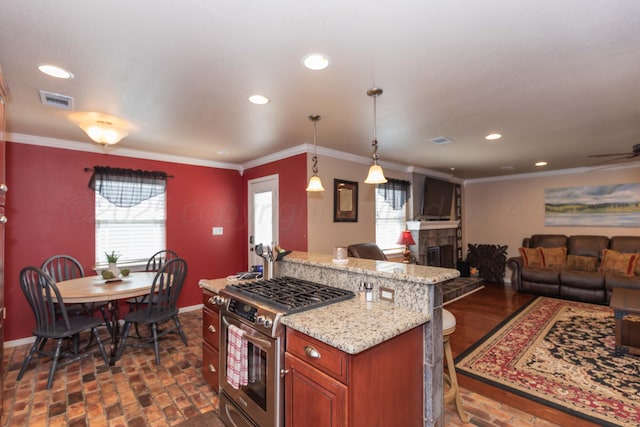 2101 Bowie St, Amarillo, TX 79109 - kitchen featuring gas stove, brick flooring, recessed lighting, open floor plan, and brown cabinets