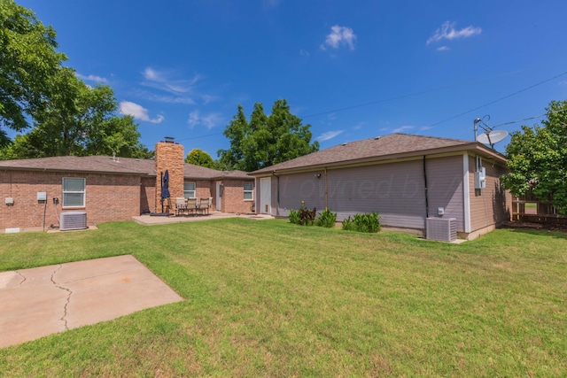 2101 Bowie St, Amarillo, TX 79109 - rear view of house featuring a chimney, a patio, and a yard