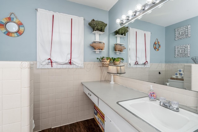 107 Elm St, Hereford, TX 79045 - bathroom with tile walls, wainscoting, wood finished floors, and vanity