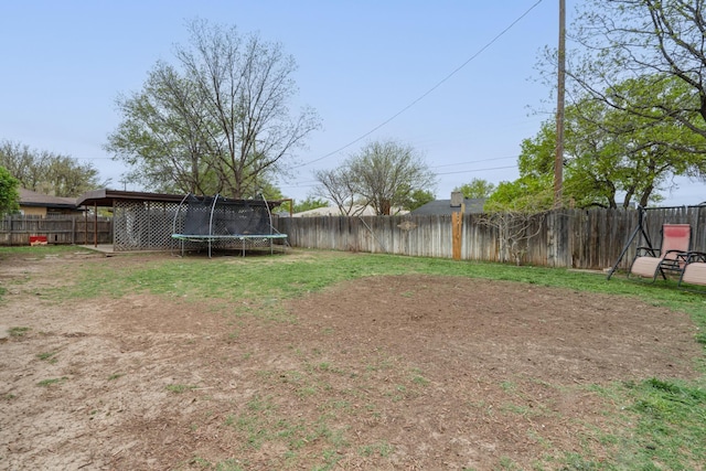 107 Elm St, Hereford, TX 79045 - view of yard featuring a trampoline and a fenced backyard