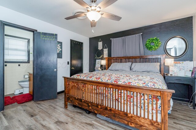 107 Elm St, Hereford, TX 79045 - bedroom featuring wood finished floors, a ceiling fan, and ensuite bathroom