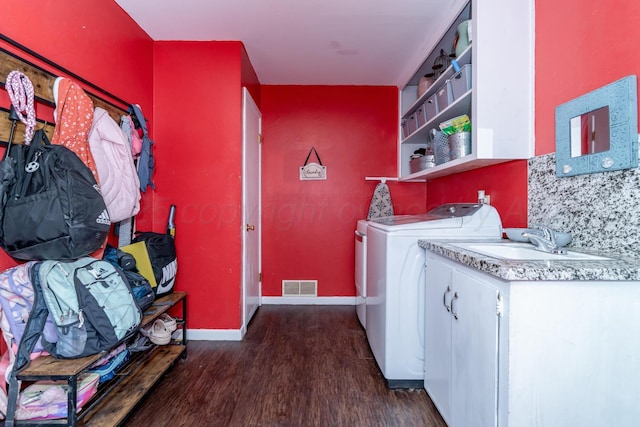 107 Elm St, Hereford, TX 79045 - washroom with dark wood finished floors, laundry area, visible vents, a sink, and baseboards