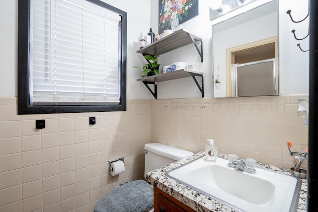 107 Elm St, Hereford, TX 79045 - bathroom featuring tile walls, vanity, toilet, and a stall shower