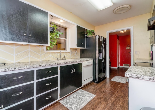 107 Elm St, Hereford, TX 79045 - kitchen featuring dark wood-style floors, dark cabinets, visible vents, a sink, and white dishwasher