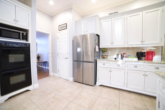 7701 Whippoorwill Ln, Amarillo, TX 79121 - kitchen with appliances with stainless steel finishes, crown molding, white cabinets, tasteful backsplash, and light stone countertops