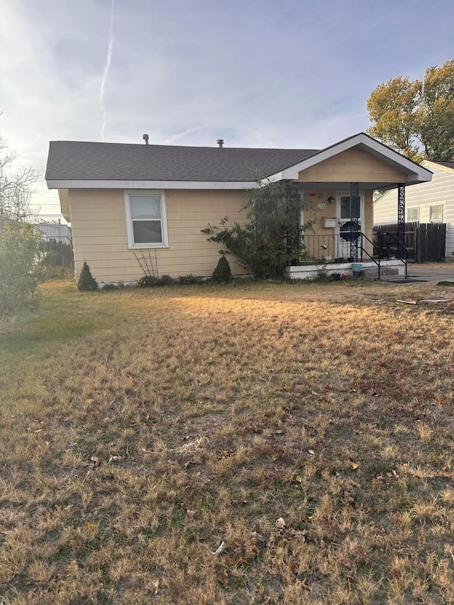 view of front of property with a porch and a front yard