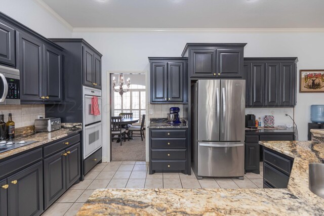 2408 Drake Elm Pl, Amarillo, TX 79124 - kitchen with appliances with stainless steel finishes, light tile patterned flooring, crown molding, backsplash, and light stone countertops