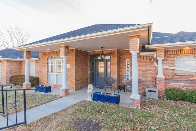2408 Drake Elm Pl, Amarillo, TX 79124 - doorway to property featuring a porch, brick siding, and roof with shingles