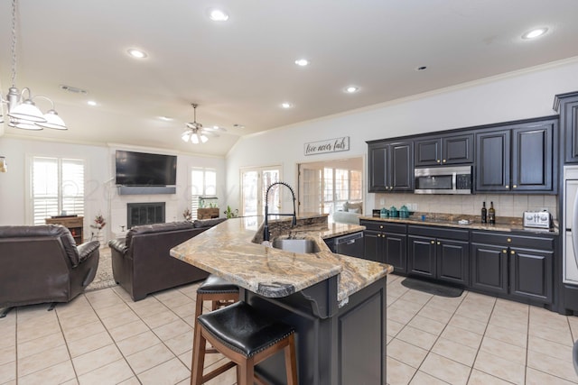 2408 Drake Elm Pl, Amarillo, TX 79124 - kitchen with stainless steel appliances, ornamental molding, a ceiling fan, light tile patterned floors, and open floor plan