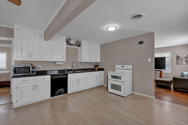 312 SW 45th Ave, Amarillo, TX 79110 - kitchen with double oven range, stainless steel microwave, black dishwasher, light wood finished floors, and dark countertops