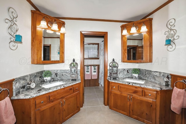 full bathroom featuring a sink, tile patterned floors, crown molding, and two vanities