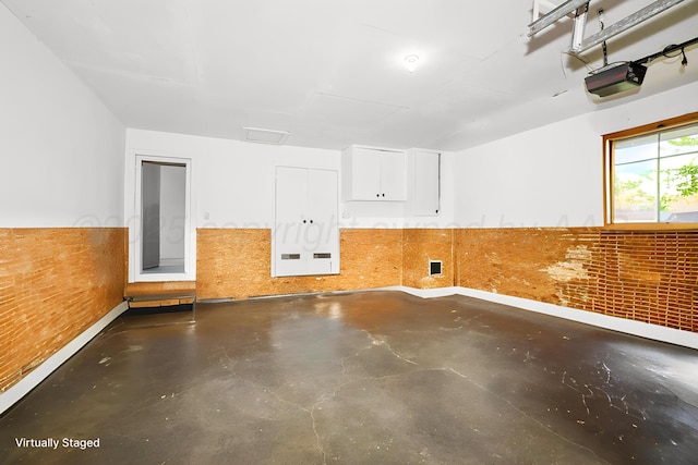 unfurnished room featuring finished concrete floors and baseboards