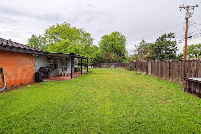 view of yard with a fenced backyard and a patio area