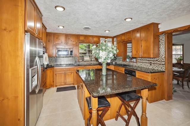 kitchen with plenty of natural light, tasteful backsplash, and stainless steel appliances