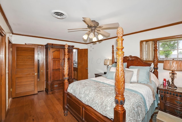 bedroom with crown molding, ceiling fan, visible vents, and wood finished floors