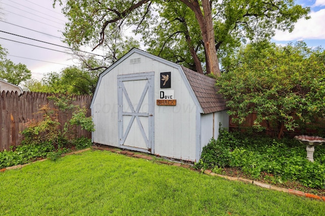 view of shed featuring fence