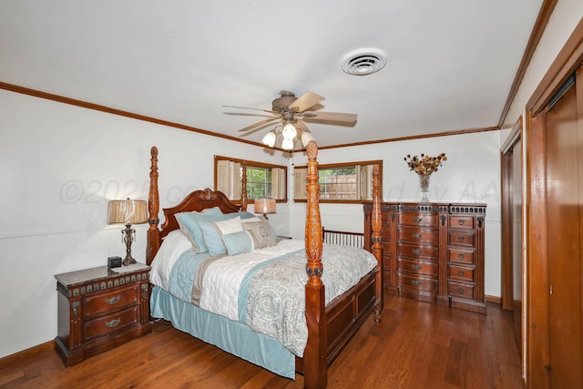 bedroom featuring visible vents, ornamental molding, dark wood finished floors, and baseboards