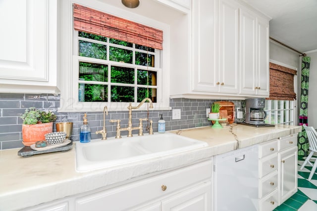 3208 S Ong St, Amarillo, TX 79109 - kitchen with white dishwasher, light countertops, and white cabinets