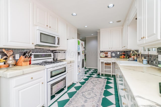 3208 S Ong St, Amarillo, TX 79109 - kitchen with white appliances, light floors, decorative backsplash, white cabinets, and recessed lighting