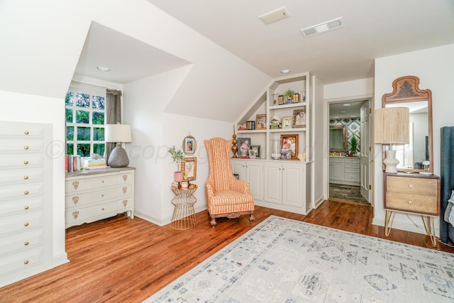 3208 S Ong St, Amarillo, TX 79109 - living area with wood finished floors, built in shelves, and vaulted ceiling