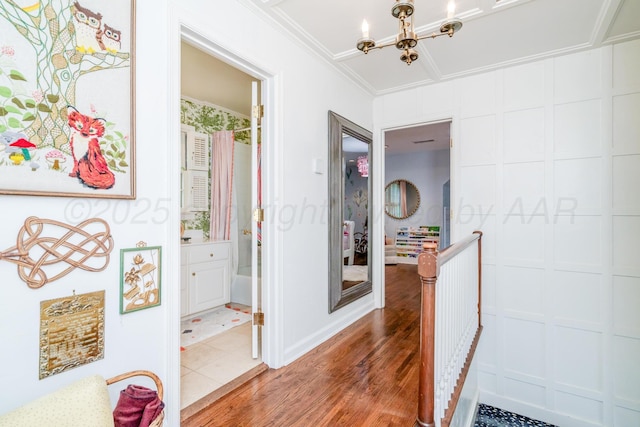3208 S Ong St, Amarillo, TX 79109 - hall featuring an upstairs landing, wood finished floors, a chandelier, and crown molding