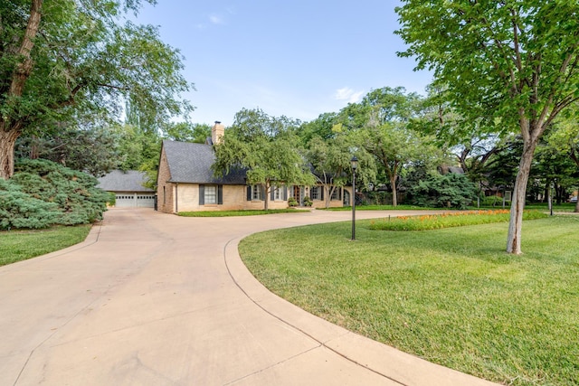 3208 S Ong St, Amarillo, TX 79109 - view of front of house featuring a front lawn, a chimney, curved driveway, a shingled roof, and brick siding