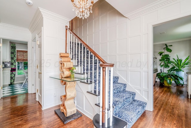 3208 S Ong St, Amarillo, TX 79109 - staircase featuring a decorative wall, crown molding, wood finished floors, and a chandelier