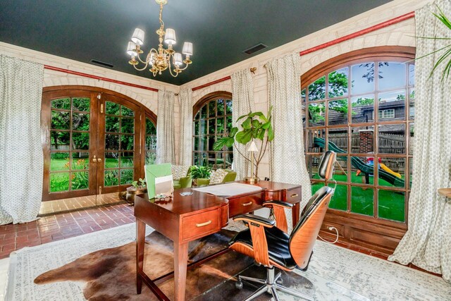 3208 S Ong St, Amarillo, TX 79109 - home office featuring french doors, a chandelier, brick patterned floors, and wallpapered walls