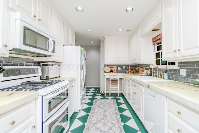 3208 S Ong St, Amarillo, TX 79109 - kitchen featuring white appliances, tile patterned floors, white cabinets, decorative backsplash, and light countertops