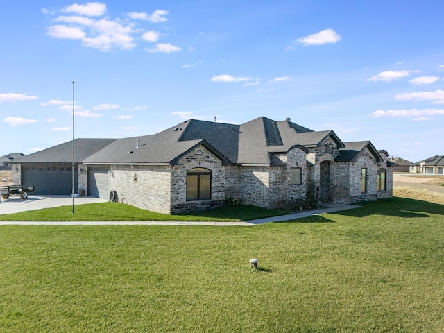 french country inspired facade featuring a garage and a front lawn