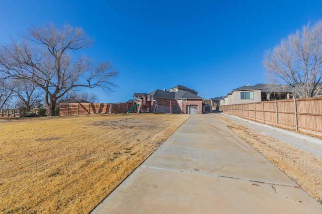 view of front facade featuring a playground, a front lawn, and a garage