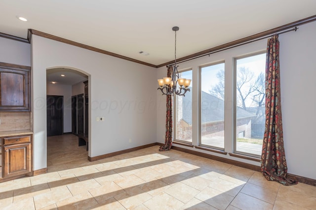 unfurnished dining area featuring an inviting chandelier, crown molding, and light tile patterned flooring