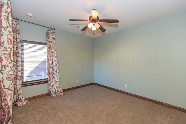 carpeted empty room featuring ceiling fan