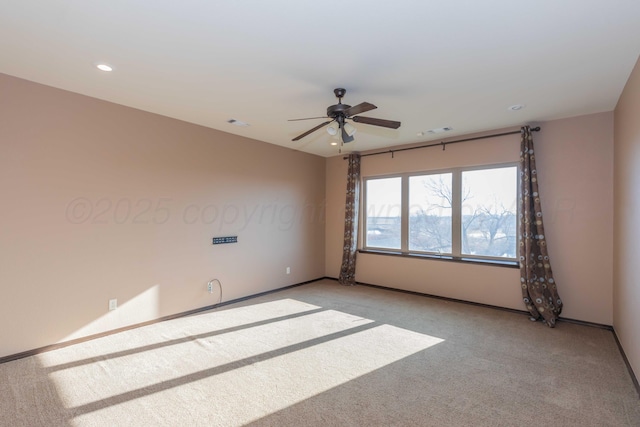 carpeted spare room with ceiling fan