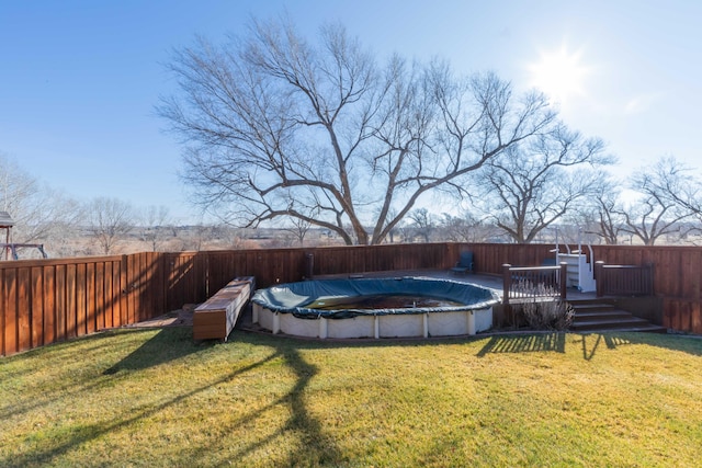 view of yard with a swimming pool side deck