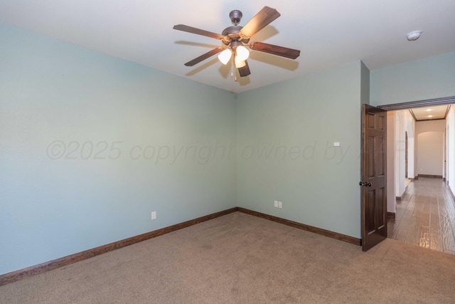 spare room featuring carpet and ceiling fan