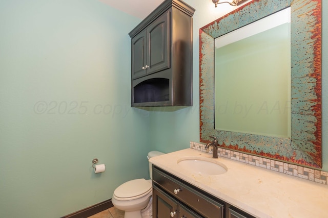 bathroom with tile patterned flooring, vanity, and toilet