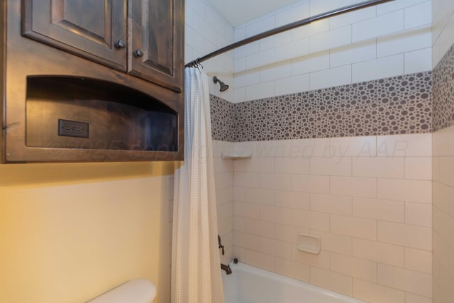 bathroom with shower / bath combo and toilet